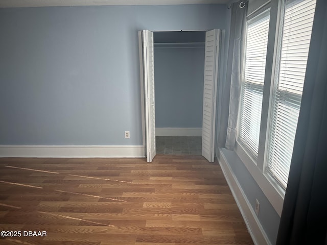 unfurnished bedroom featuring dark wood-type flooring