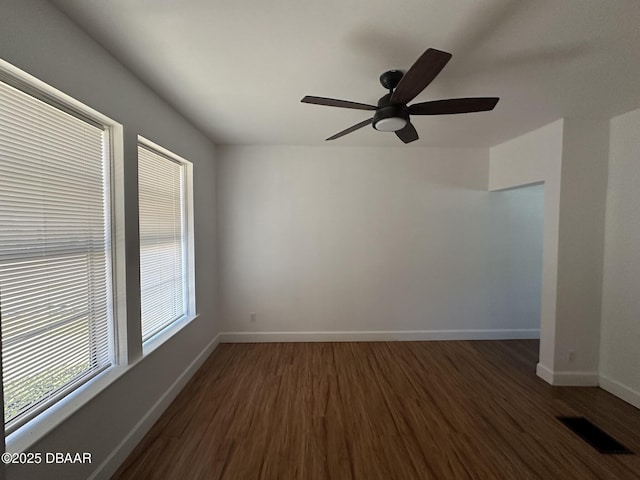 empty room featuring ceiling fan and dark hardwood / wood-style flooring