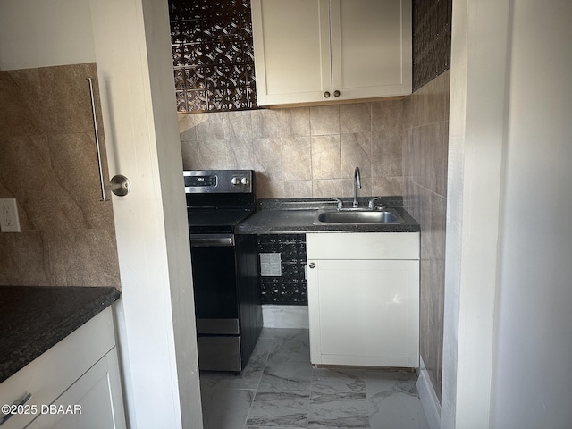 kitchen with electric stove, sink, and tasteful backsplash