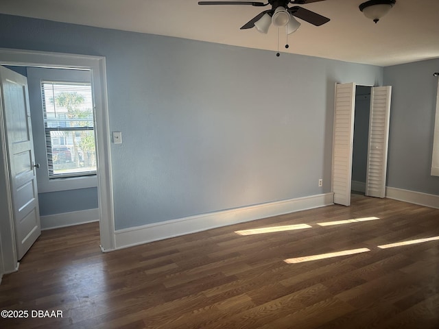 spare room with ceiling fan and dark hardwood / wood-style floors