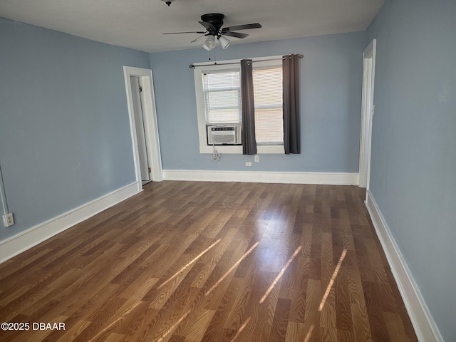 empty room featuring dark wood-type flooring, cooling unit, and ceiling fan