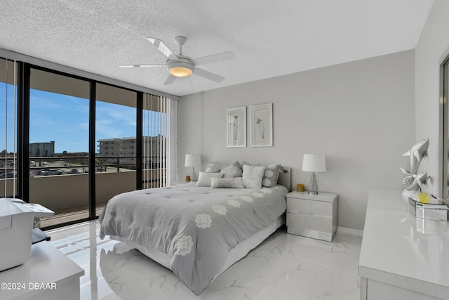 bedroom with access to exterior, a textured ceiling, ceiling fan, and floor to ceiling windows