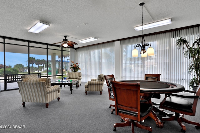 carpeted dining space featuring a textured ceiling, ceiling fan, and a wall of windows