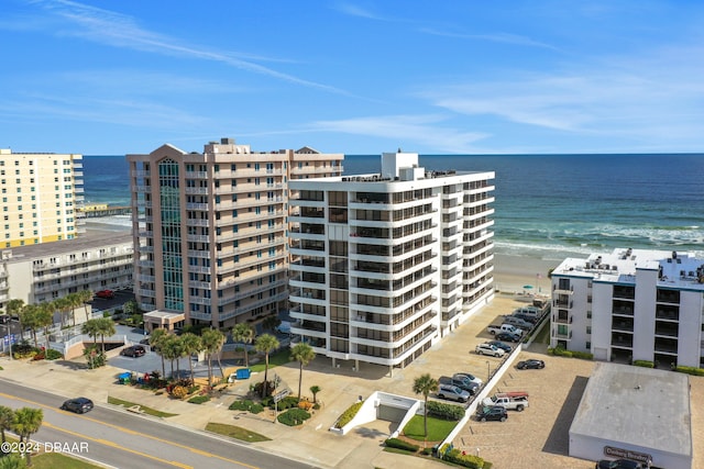 view of property with a beach view and a water view