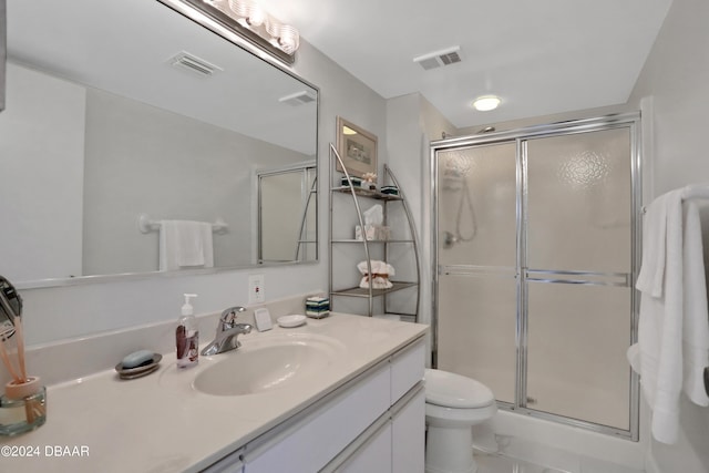 bathroom with walk in shower, vanity, and toilet