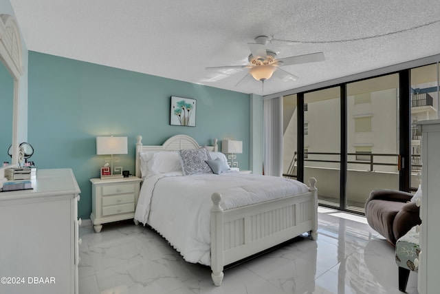 bedroom featuring a wall of windows, a textured ceiling, ceiling fan, and access to exterior