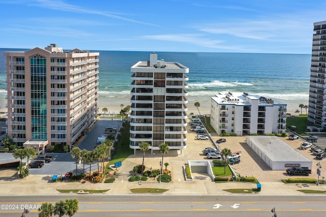 view of property with a beach view and a water view