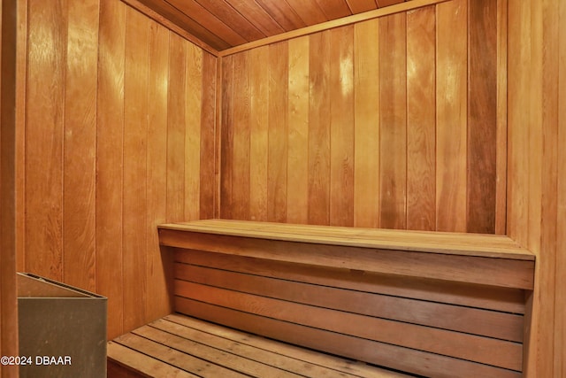 view of sauna featuring wooden walls and wooden ceiling