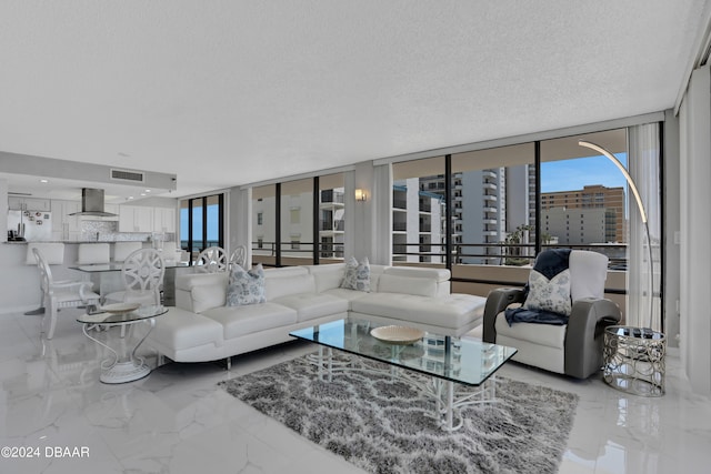 living room with floor to ceiling windows and a textured ceiling