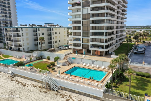 view of building exterior featuring a community pool