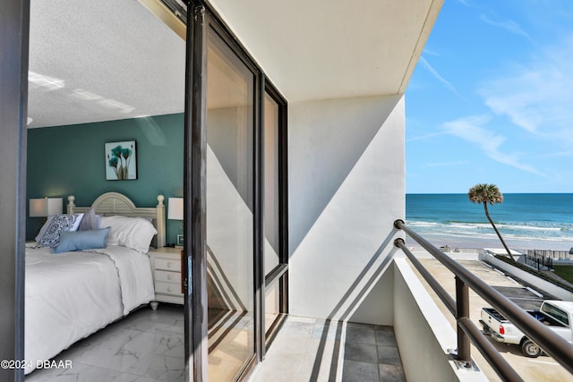 balcony with a beach view and a water view