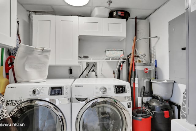 laundry area with cabinets, independent washer and dryer, and electric water heater