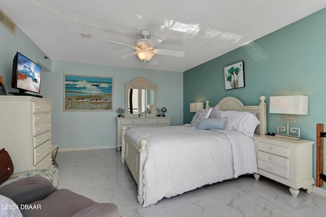 bedroom featuring a textured ceiling and ceiling fan