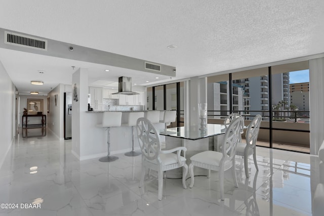 unfurnished dining area featuring expansive windows and a textured ceiling