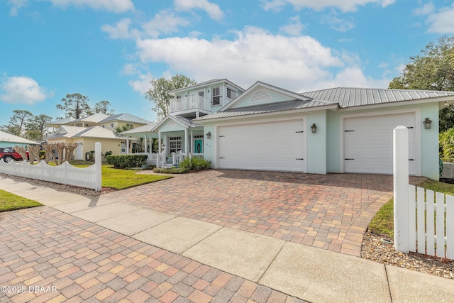 view of front of property featuring a garage and a balcony