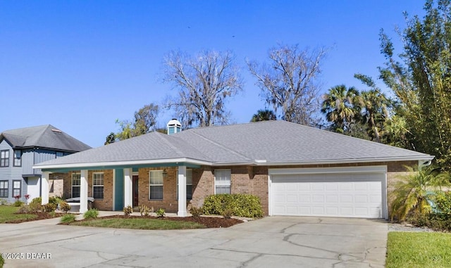 view of front of home with concrete driveway, an attached garage, a shingled roof, brick siding, and a chimney