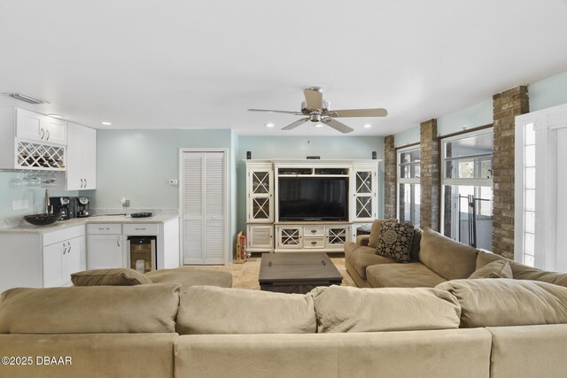 living room featuring visible vents, a ceiling fan, recessed lighting, wine cooler, and indoor bar