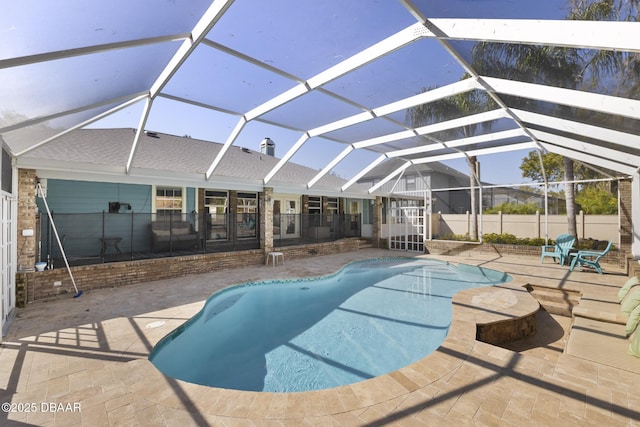 view of swimming pool with a fenced in pool, a patio, glass enclosure, and fence