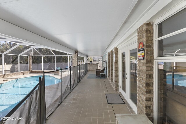 view of pool with a fenced in pool, a patio, and glass enclosure