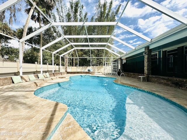 view of pool featuring a fenced in pool, a patio, a fenced backyard, and glass enclosure