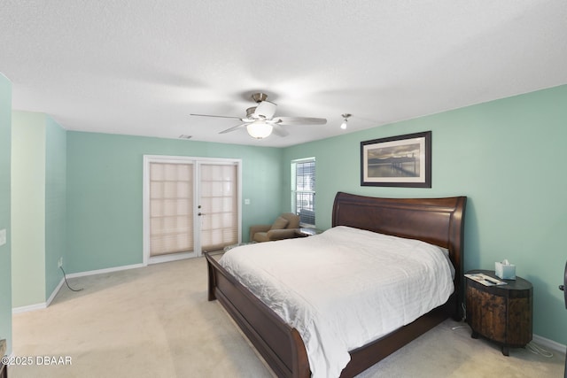 bedroom featuring light colored carpet, access to exterior, a ceiling fan, and baseboards