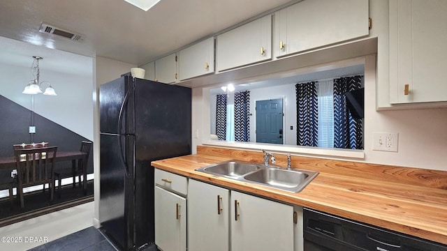 kitchen with sink, black appliances, an inviting chandelier, white cabinetry, and hanging light fixtures