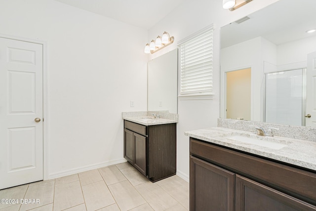 full bathroom featuring visible vents, a stall shower, two vanities, a sink, and tile patterned floors
