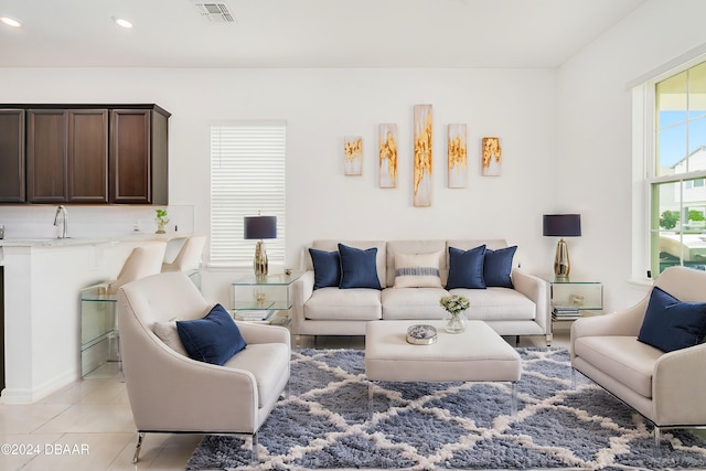living area featuring light tile patterned floors, recessed lighting, and visible vents