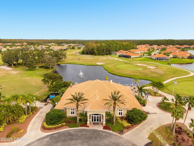 drone / aerial view with a water view, view of golf course, and a residential view