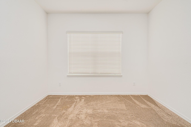 unfurnished room featuring baseboards and carpet flooring