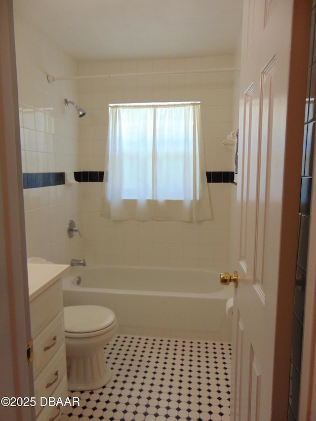 bathroom with  shower combination, tile patterned flooring, vanity, and toilet