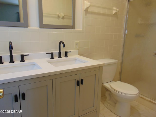 full bathroom with a stall shower, a sink, tasteful backsplash, and toilet
