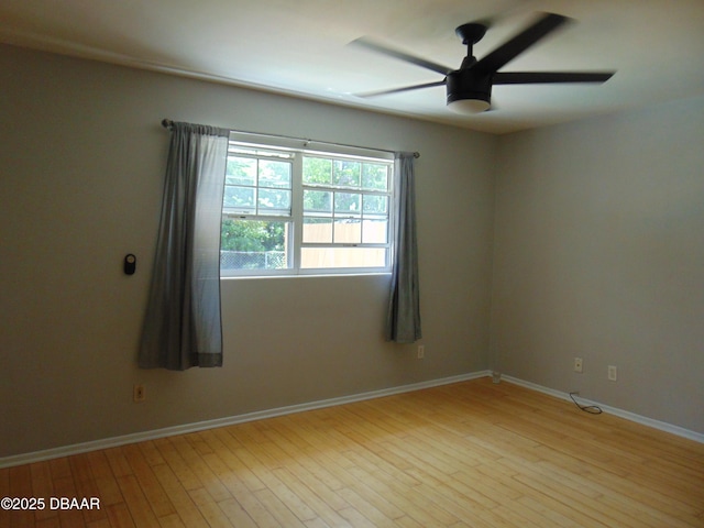 empty room featuring light wood-style flooring, baseboards, and ceiling fan