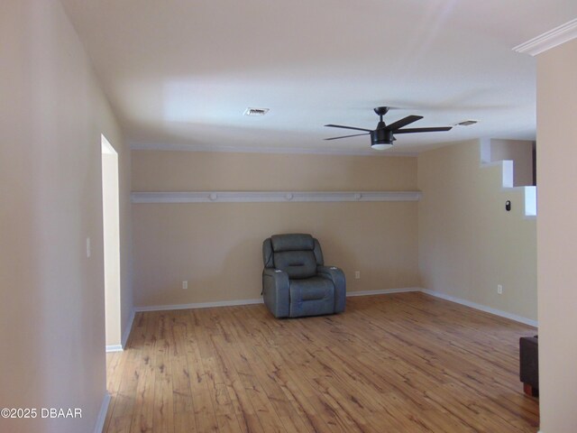 unfurnished room featuring wood-type flooring, visible vents, a ceiling fan, and baseboards