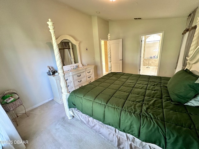 carpeted bedroom with connected bathroom and lofted ceiling