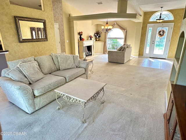 living room featuring carpet flooring, high vaulted ceiling, and a chandelier