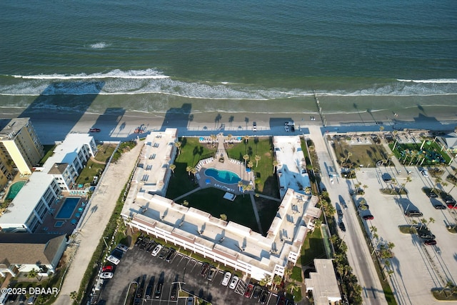 birds eye view of property with a water view and a view of the beach