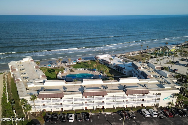 birds eye view of property with a water view and a view of the beach