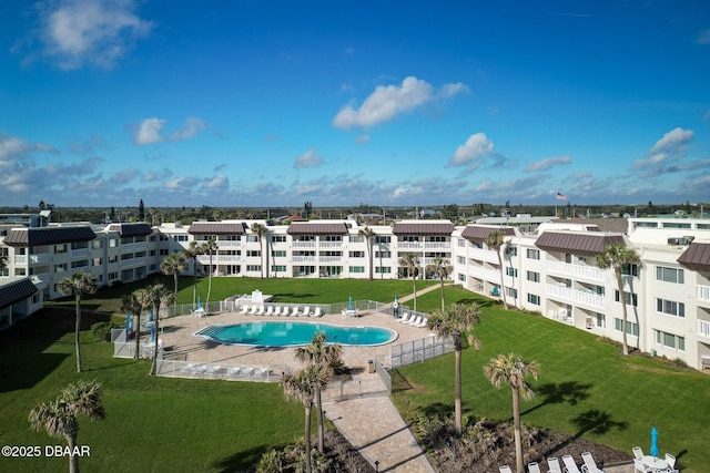 view of swimming pool featuring a patio and a lawn