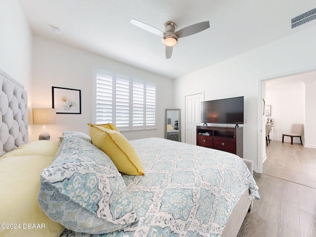 bedroom with ceiling fan and light hardwood / wood-style floors