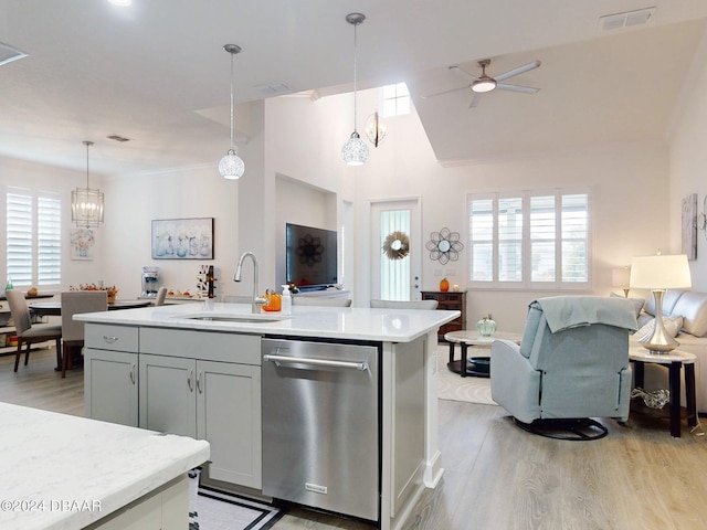 kitchen featuring a healthy amount of sunlight, hanging light fixtures, sink, and dishwasher