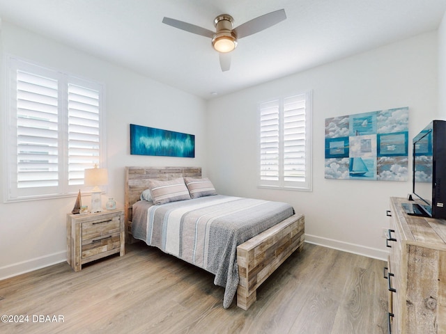 bedroom with ceiling fan and light wood-type flooring