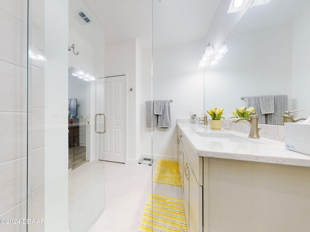 bathroom featuring tile patterned flooring and vanity