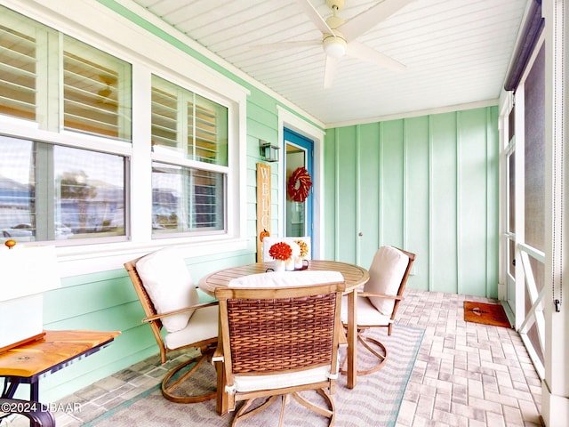 sunroom featuring ceiling fan