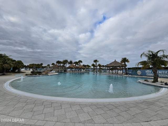 view of swimming pool with pool water feature