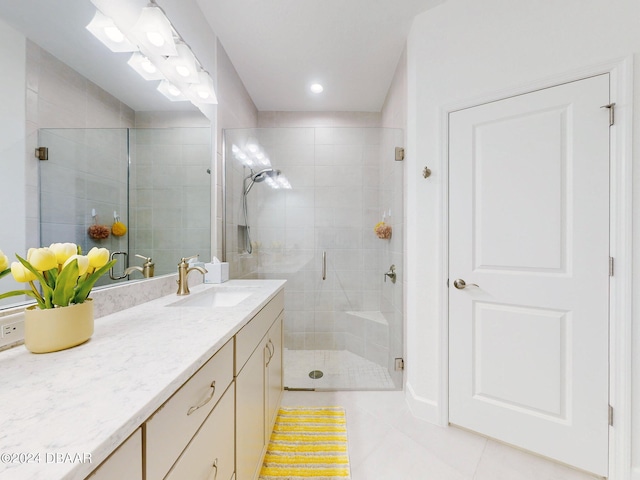 bathroom with walk in shower, tile patterned floors, and vanity