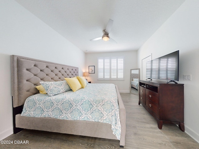 bedroom with light hardwood / wood-style flooring and ceiling fan