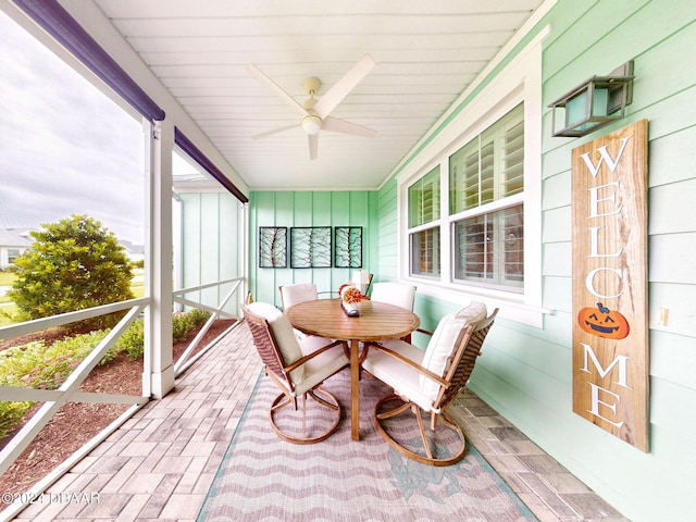 sunroom / solarium featuring ceiling fan