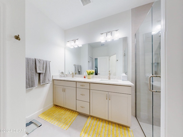 bathroom featuring vanity, tile patterned floors, and a shower with shower door