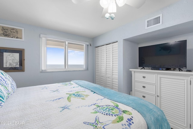 bedroom featuring ceiling fan and a closet